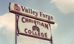 An old picture of a sign that says Valley Forge Christian College.